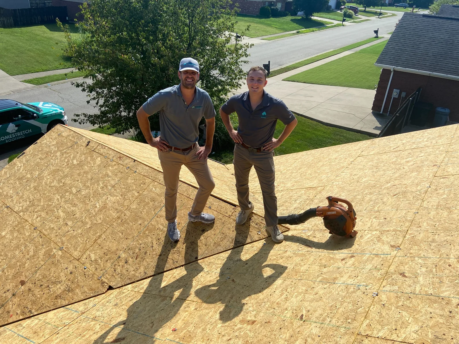 Roofing crew working on a new asphalt shingle installation
