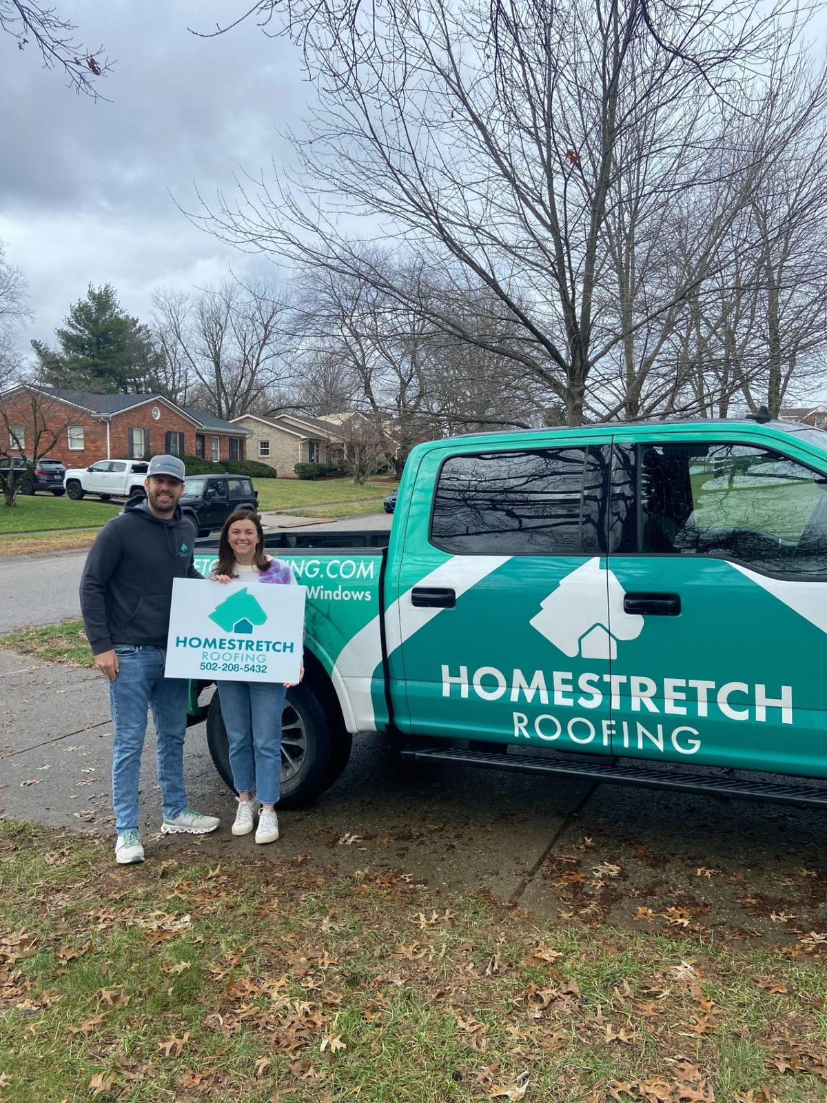 Homestretch Roofing branded truck with team
